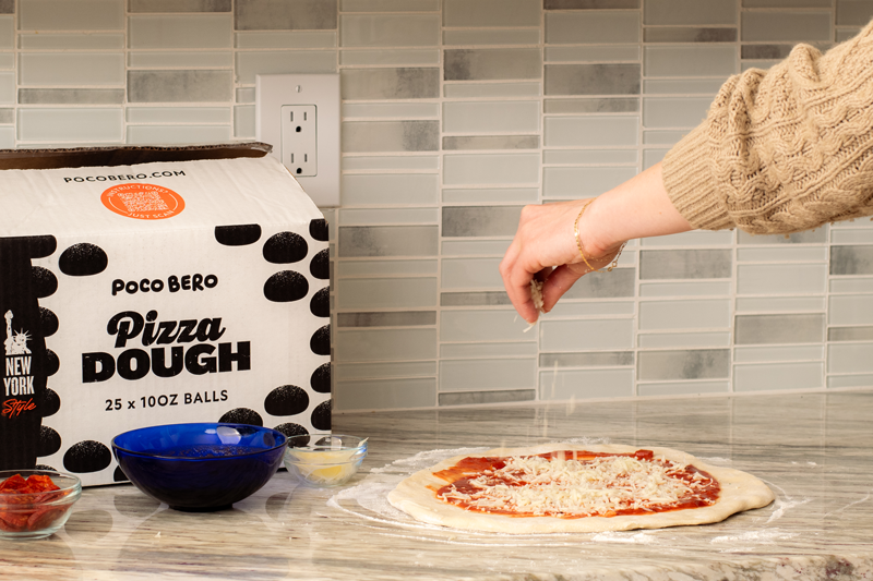 Pizza being placed into an oven